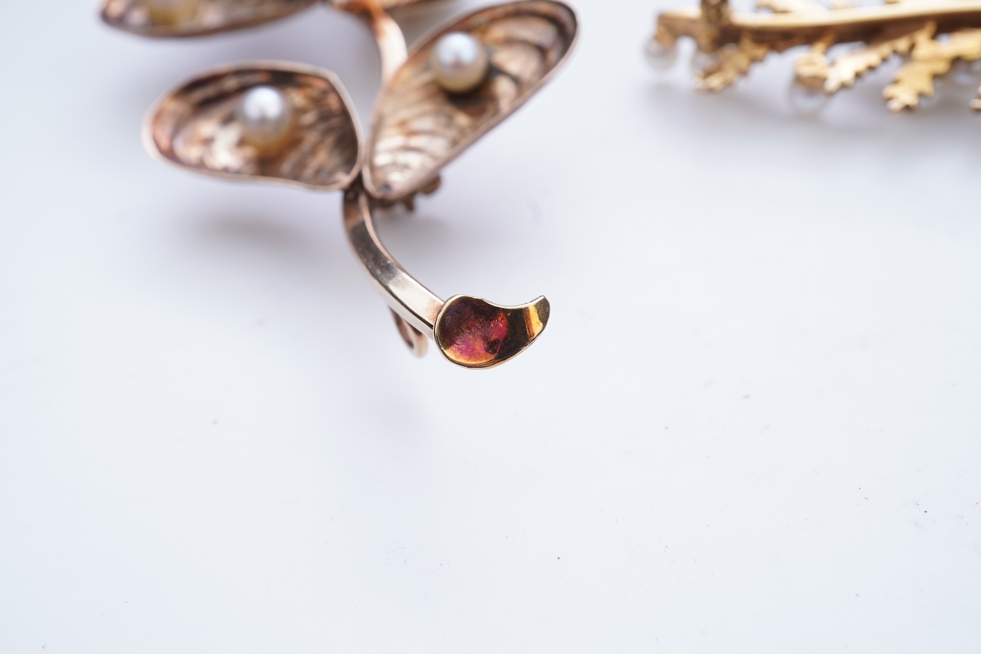 Two cultured pearl brooches